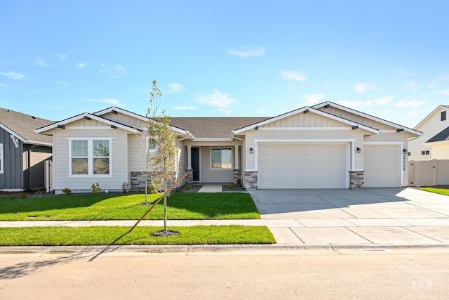 view of front of property featuring a front lawn, fence, board and batten siding, concrete driveway, and a garage