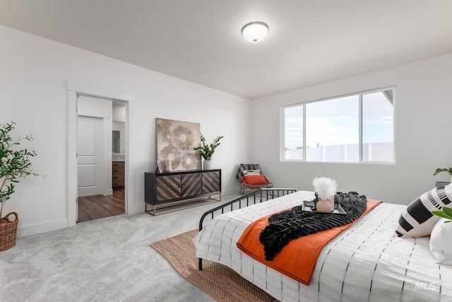 carpeted bedroom featuring baseboards