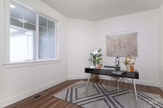 office with wood finished floors, visible vents, and baseboards