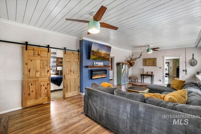 353 7th Ave E, Twin Falls, ID 83301 - living room featuring a ceiling fan, a barn door, wood ceiling, crown molding, and a large fireplace