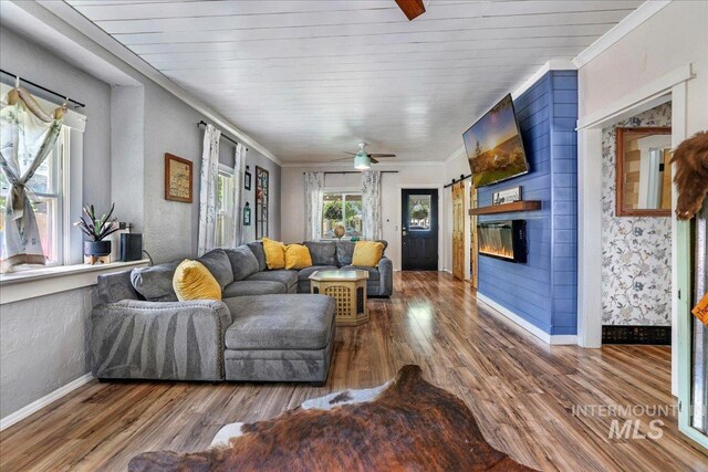 353 7th Ave E, Twin Falls, ID 83301 - living area with baseboards, wood finished floors, ornamental molding, ceiling fan, and a glass covered fireplace