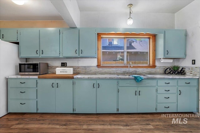 353 7th Ave E, Twin Falls, ID 83301 - kitchen with stainless steel microwave, a sink, light countertops, dark wood-type flooring, and blue cabinets