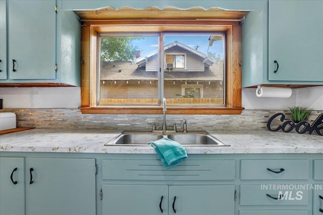 353 7th Ave E, Twin Falls, ID 83301 - kitchen featuring a sink, light countertops, healthy amount of natural light, and decorative backsplash