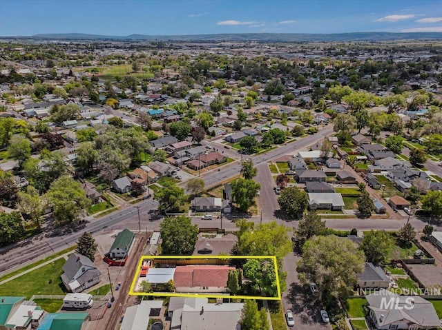 353 7th Ave E, Twin Falls, ID 83301 - aerial perspective of suburban area with property boundaries highlighted and a mountain backdrop