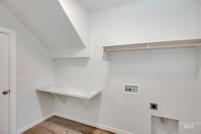 washroom with hookup for an electric dryer, laundry area, washer hookup, wood finished floors, and baseboards