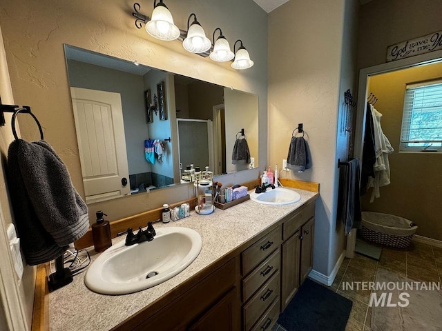 bathroom featuring tile patterned flooring, walk in shower, and vanity