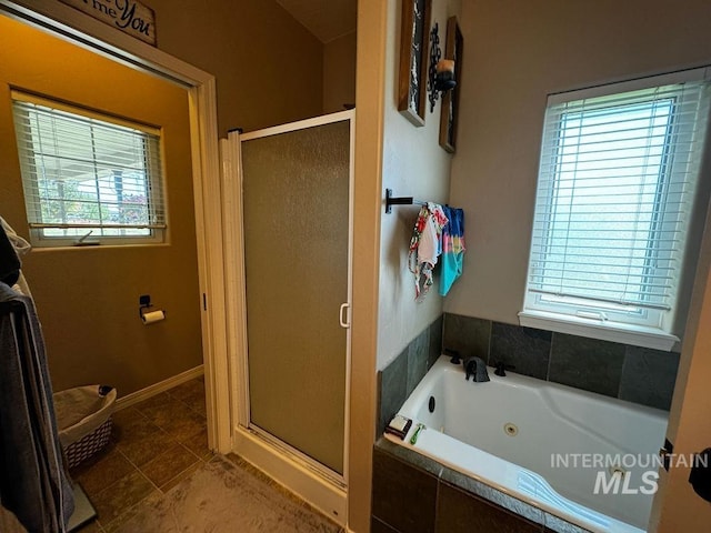 bathroom with plenty of natural light, tile patterned flooring, and plus walk in shower