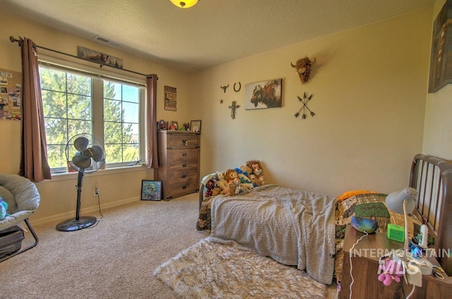 carpeted bedroom featuring a textured ceiling