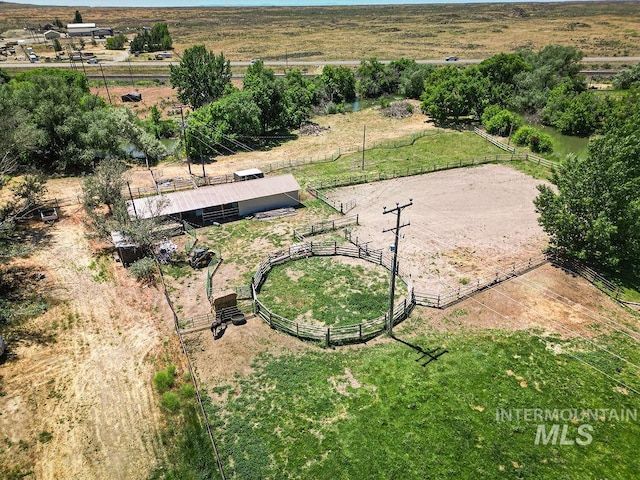 birds eye view of property with a rural view