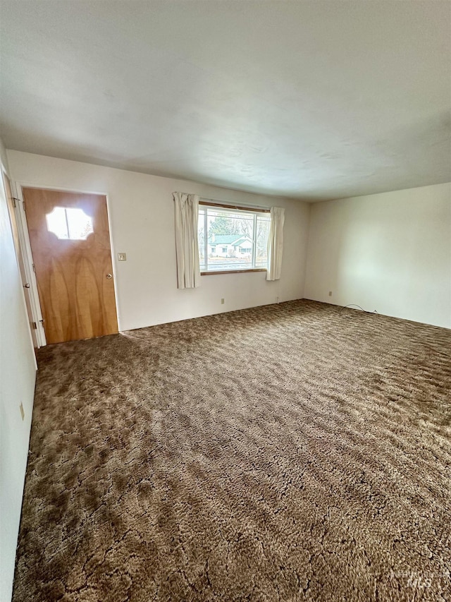 unfurnished living room featuring carpet flooring