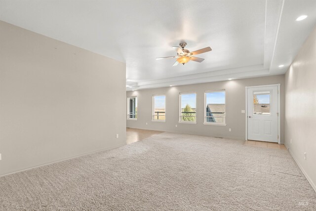 3017 Cypress St, Lewiston, ID 83501 - unfurnished living room featuring light colored carpet, a ceiling fan, a raised ceiling, recessed lighting, and baseboards