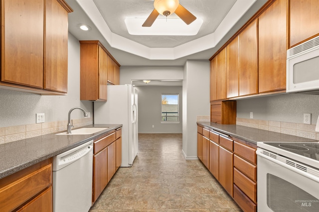 3017 Cypress St, Lewiston, ID 83501 - kitchen featuring white appliances, a sink, a ceiling fan, dark countertops, and brown cabinetry