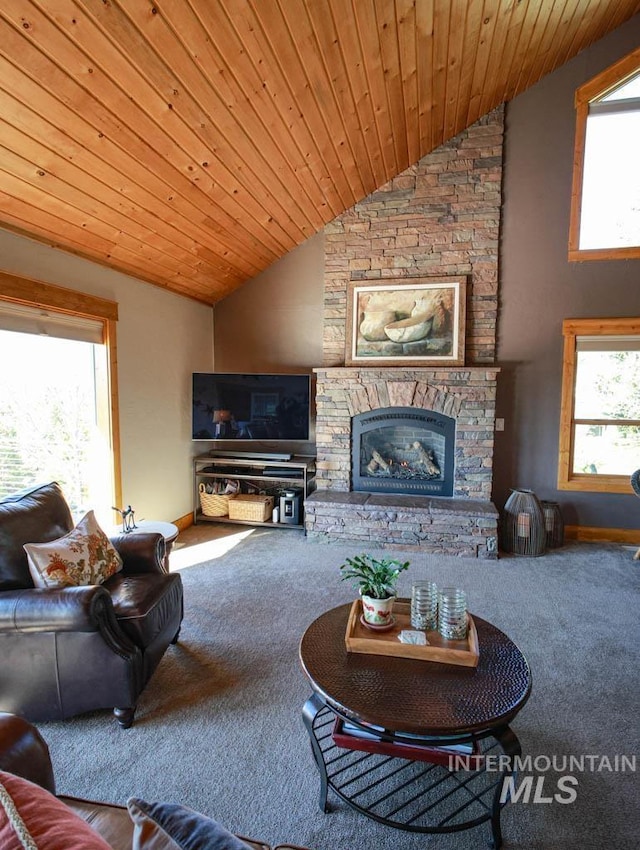 986 Valley Rim Rd, Mccall, ID 83638 - carpeted living room with vaulted ceiling, a stone fireplace, and wooden ceiling