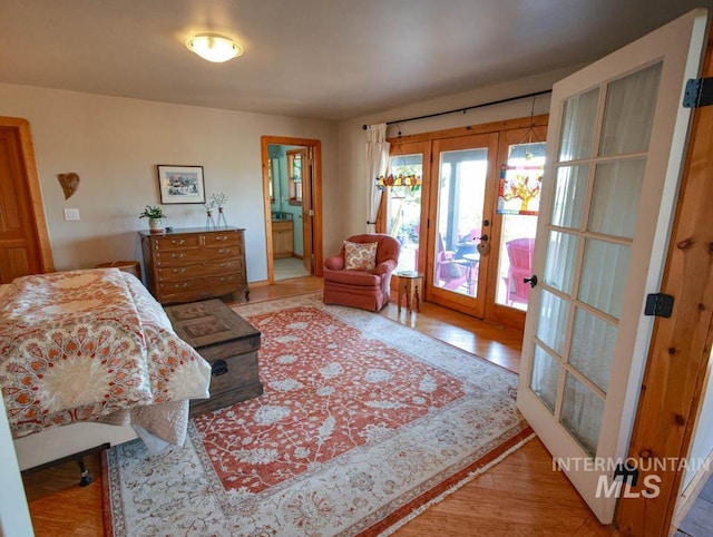 986 Valley Rim Rd, Mccall, ID 83638 - bedroom with french doors, access to exterior, wood finished floors, and connected bathroom