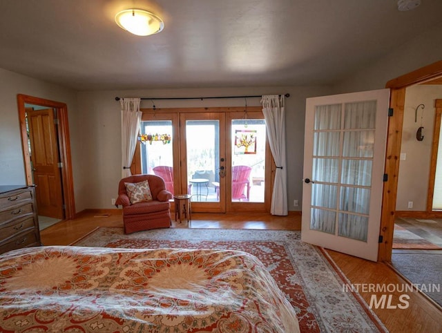 986 Valley Rim Rd, Mccall, ID 83638 - bedroom with french doors, access to exterior, baseboards, and wood finished floors