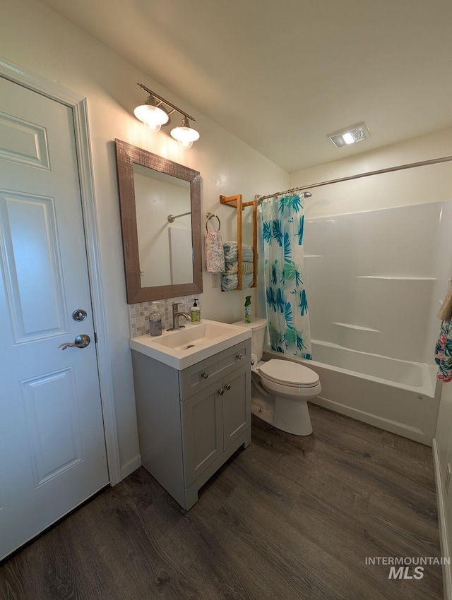 232 Camas Rd, Grangeville, ID 83530 - bathroom featuring wood finished floors, toilet, shower / bathtub combination with curtain, and vanity