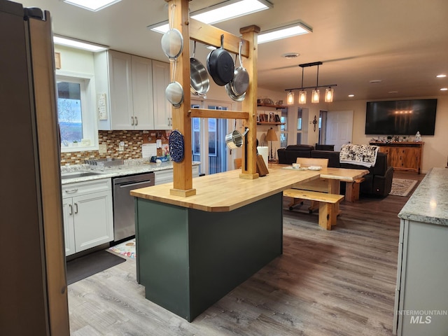 232 Camas Rd, Grangeville, ID 83530 - kitchen featuring appliances with stainless steel finishes, wood counters, open floor plan, wood finished floors, and white cabinetry