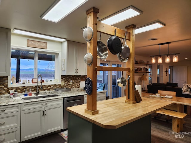232 Camas Rd, Grangeville, ID 83530 - kitchen featuring butcher block countertops, a sink, dishwasher, tasteful backsplash, and pendant lighting