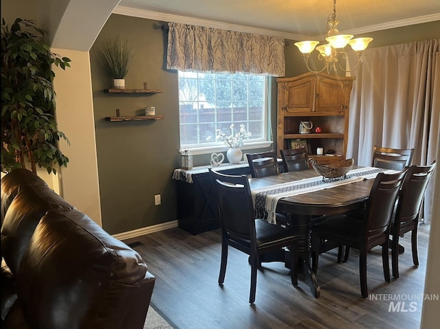 dining area with ornamental molding, a chandelier, baseboards, and dark wood-style floors