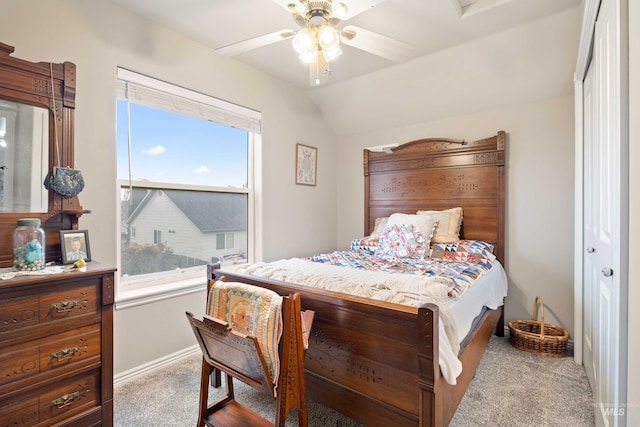 bedroom with carpet, baseboards, lofted ceiling, and ceiling fan