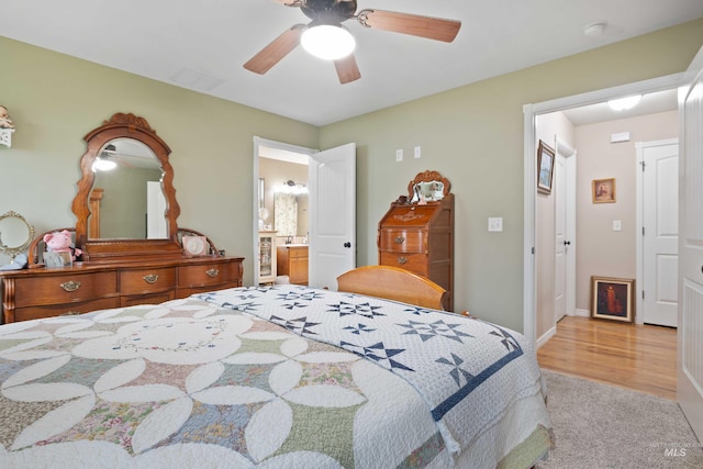 bedroom featuring carpet floors, ensuite bath, a ceiling fan, and baseboards
