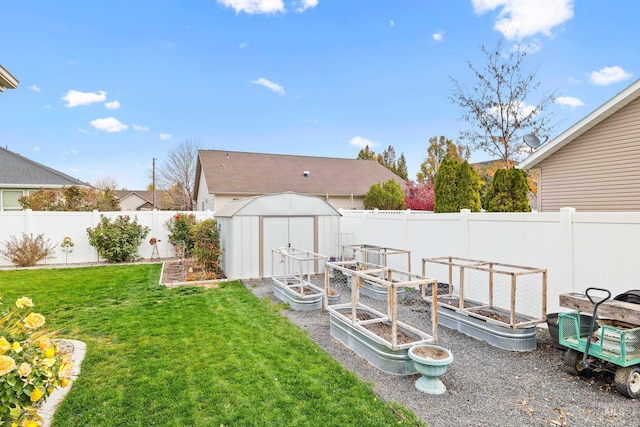 view of yard with a vegetable garden, a shed, and an outdoor structure