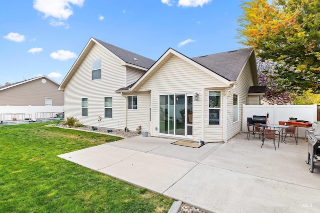 back of house featuring a patio, a shingled roof, and outdoor dining area