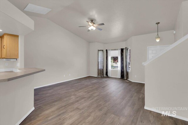 555 W Mulberry Loop, Nampa, ID 83686 - unfurnished living room with a ceiling fan, dark wood finished floors, and vaulted ceiling