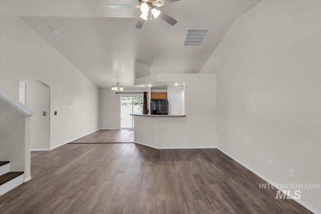 555 W Mulberry Loop, Nampa, ID 83686 - unfurnished living room featuring ceiling fan, lofted ceiling, stairs, dark wood-type flooring, and a chandelier