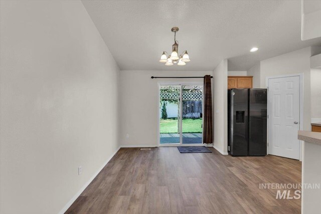 555 W Mulberry Loop, Nampa, ID 83686 - unfurnished dining area with a chandelier and wood finished floors