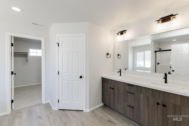 11075 W Windmill Way, Nampa, ID 83651 - full bathroom featuring walk in shower, visible vents, a sink, and wood finished floors