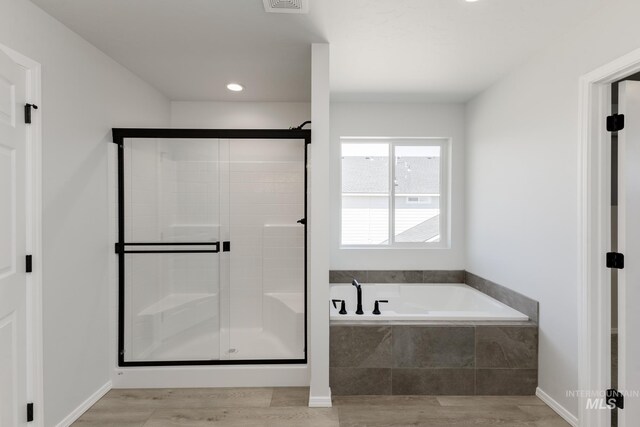 11075 W Windmill Way, Nampa, ID 83651 - full bathroom with a stall shower, recessed lighting, visible vents, a garden tub, and wood finished floors