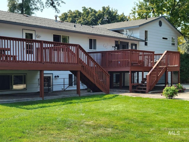 rear view of property featuring a lawn and a deck