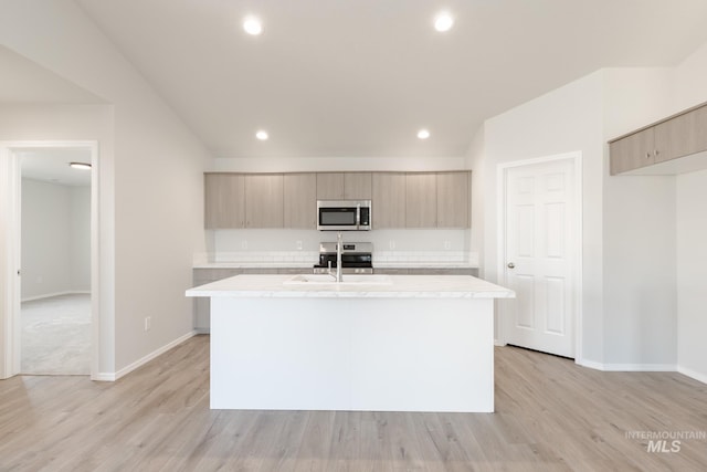 kitchen featuring appliances with stainless steel finishes, modern cabinets, light countertops, and a sink