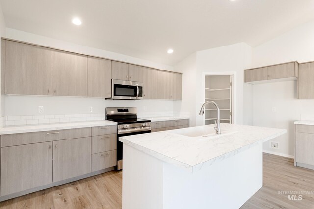 kitchen featuring a sink, modern cabinets, appliances with stainless steel finishes, and light brown cabinets