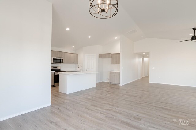 unfurnished living room featuring light wood-style flooring, ceiling fan with notable chandelier, visible vents, and baseboards
