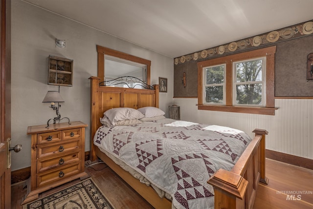 1507 Scheloske Rd, Weiser, ID 83672 - bedroom featuring wood finished floors and a wainscoted wall