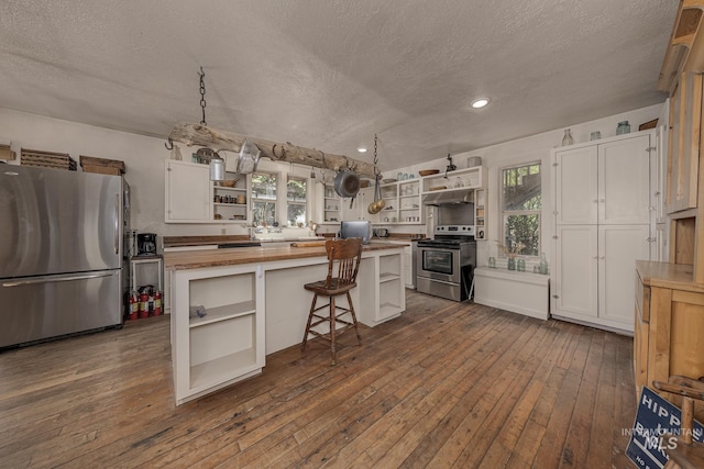 1507 Scheloske Rd, Weiser, ID 83672 - kitchen with open shelves, stainless steel appliances, butcher block countertops, a textured ceiling, and a kitchen island