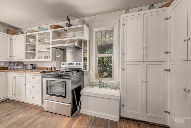 1507 Scheloske Rd, Weiser, ID 83672 - kitchen with stainless steel electric range, wall chimney exhaust hood, open shelves, white cabinets, and hardwood / wood-style floors