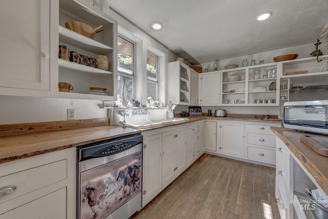1507 Scheloske Rd, Weiser, ID 83672 - kitchen with open shelves, stainless steel dishwasher, butcher block countertops, white cabinets, and light wood finished floors