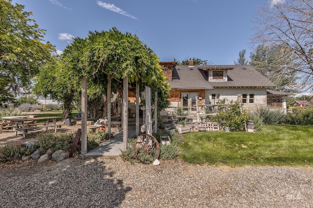 1507 Scheloske Rd, Weiser, ID 83672 - back of house with a chimney, a yard, and a shingled roof