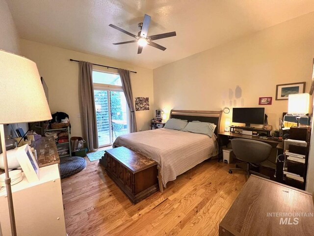 bedroom featuring access to exterior, light wood-type flooring, and ceiling fan
