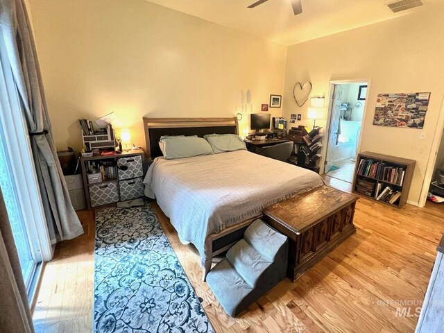 bedroom with visible vents, light wood-style flooring, and a ceiling fan