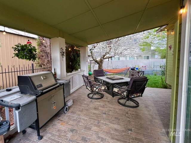 view of patio / terrace with outdoor dining space and fence