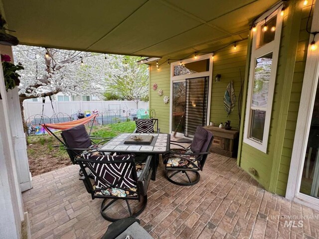 view of patio / terrace with outdoor dining space and fence