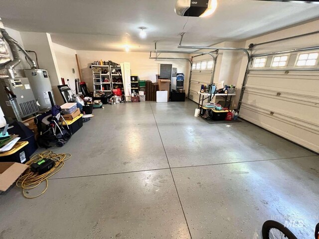 garage featuring water heater and a garage door opener