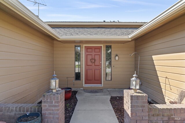 11185 W Humming Bird Dr, Boise, ID 83709 - doorway to property featuring roof with shingles