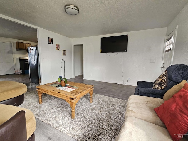 living room with a textured ceiling and wood finished floors