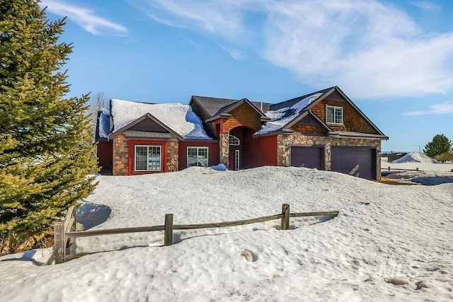 view of front of home with stone siding and fence