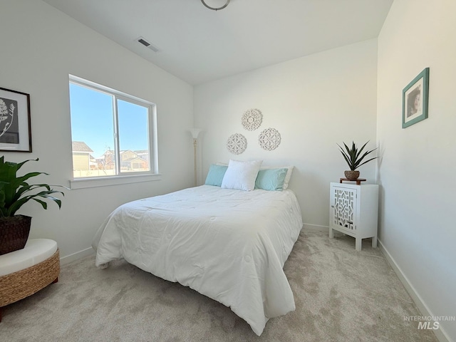 carpeted bedroom featuring visible vents and baseboards